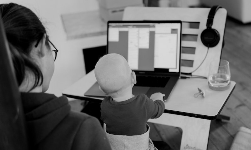 Lady working from home with baby on her lap